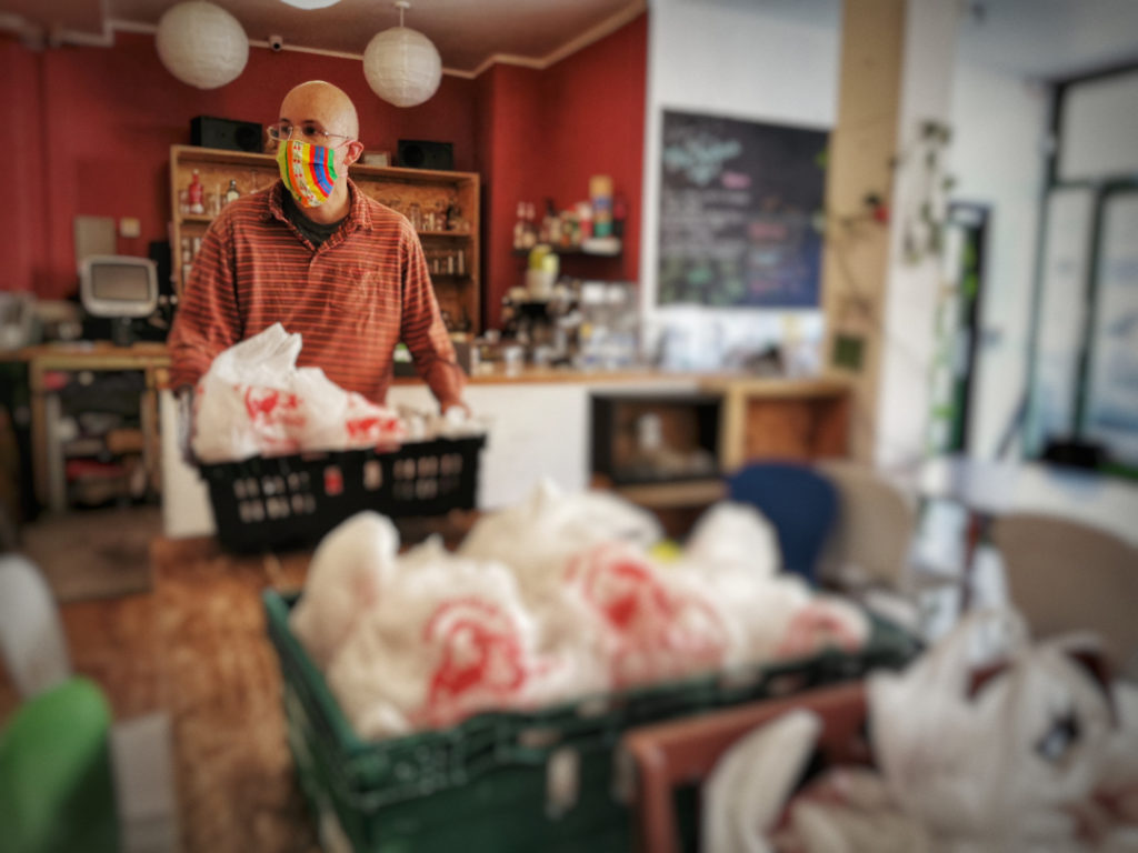 A volunteer moving the prepared meals ready for pick up